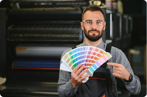 Man holding color pallets in hand in 1HomeOffice Printing Shop.